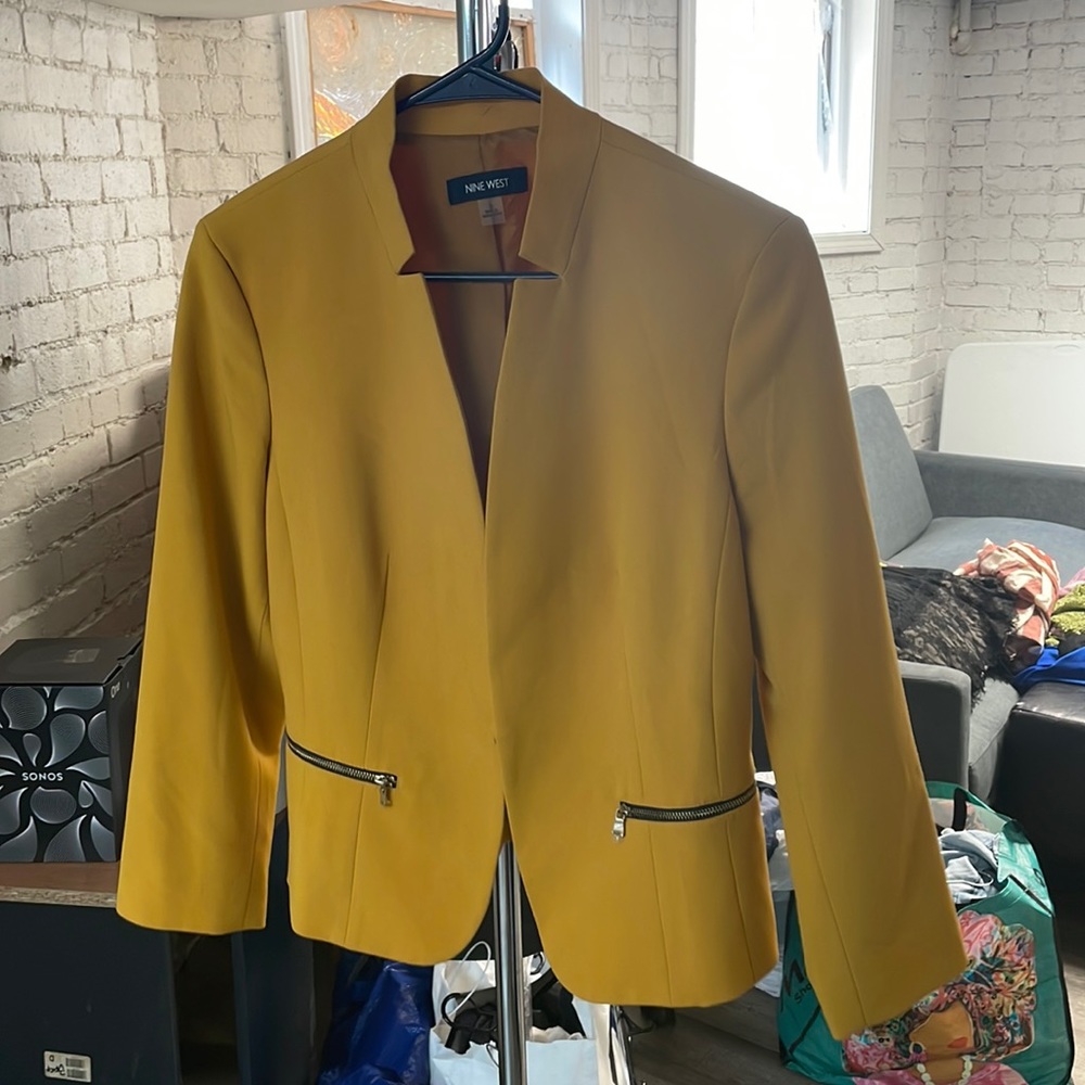 Adorable mustard crooked jacket with zippers.